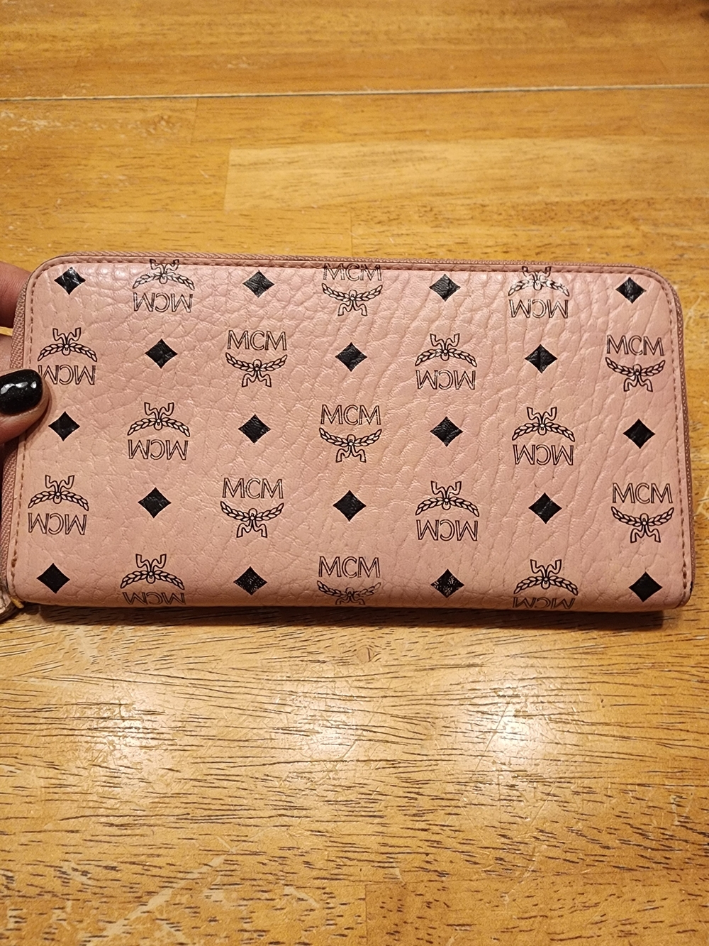 pink MCM Visetos monogram zip-around wallet featuring the brand's classic Mono